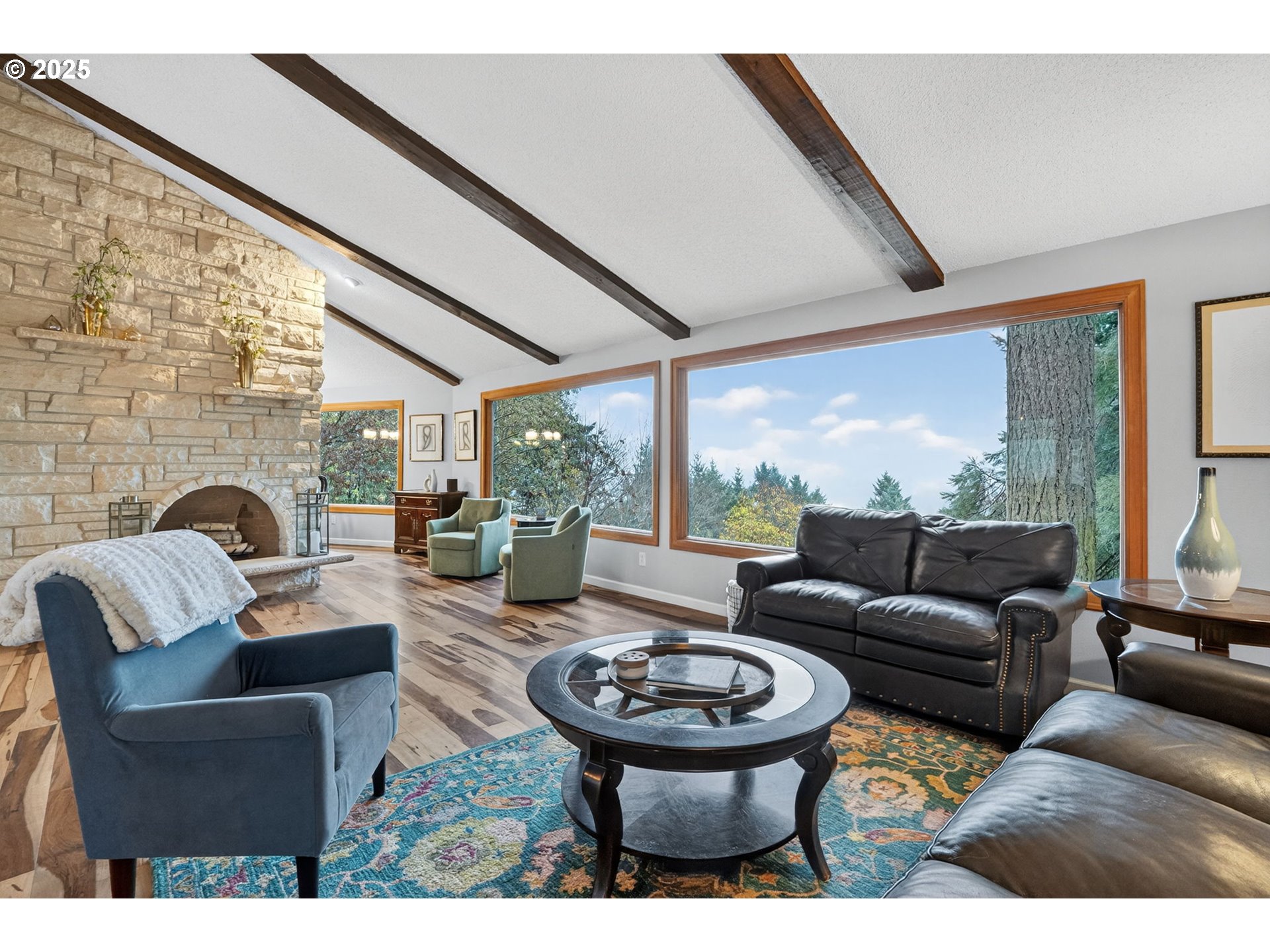 17542 Kirkwood Road Gladstone, OR 97027 - Photo 8 of 48 a living room with furniture a fireplace and large windows