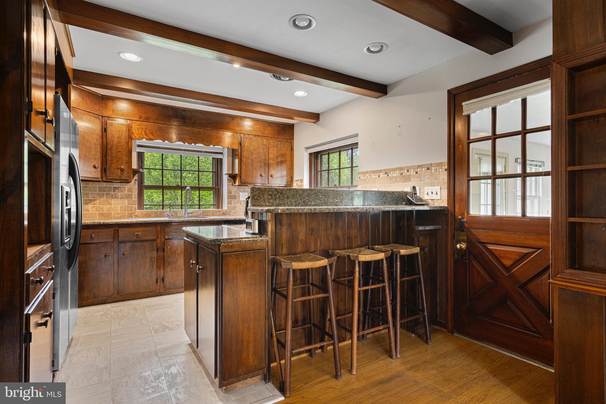 71 Forest Lane Swarthmore, PA 19081 - Photo 13 of 33 a kitchen with stainless steel appliances granite countertop a table chairs and a refrigerator