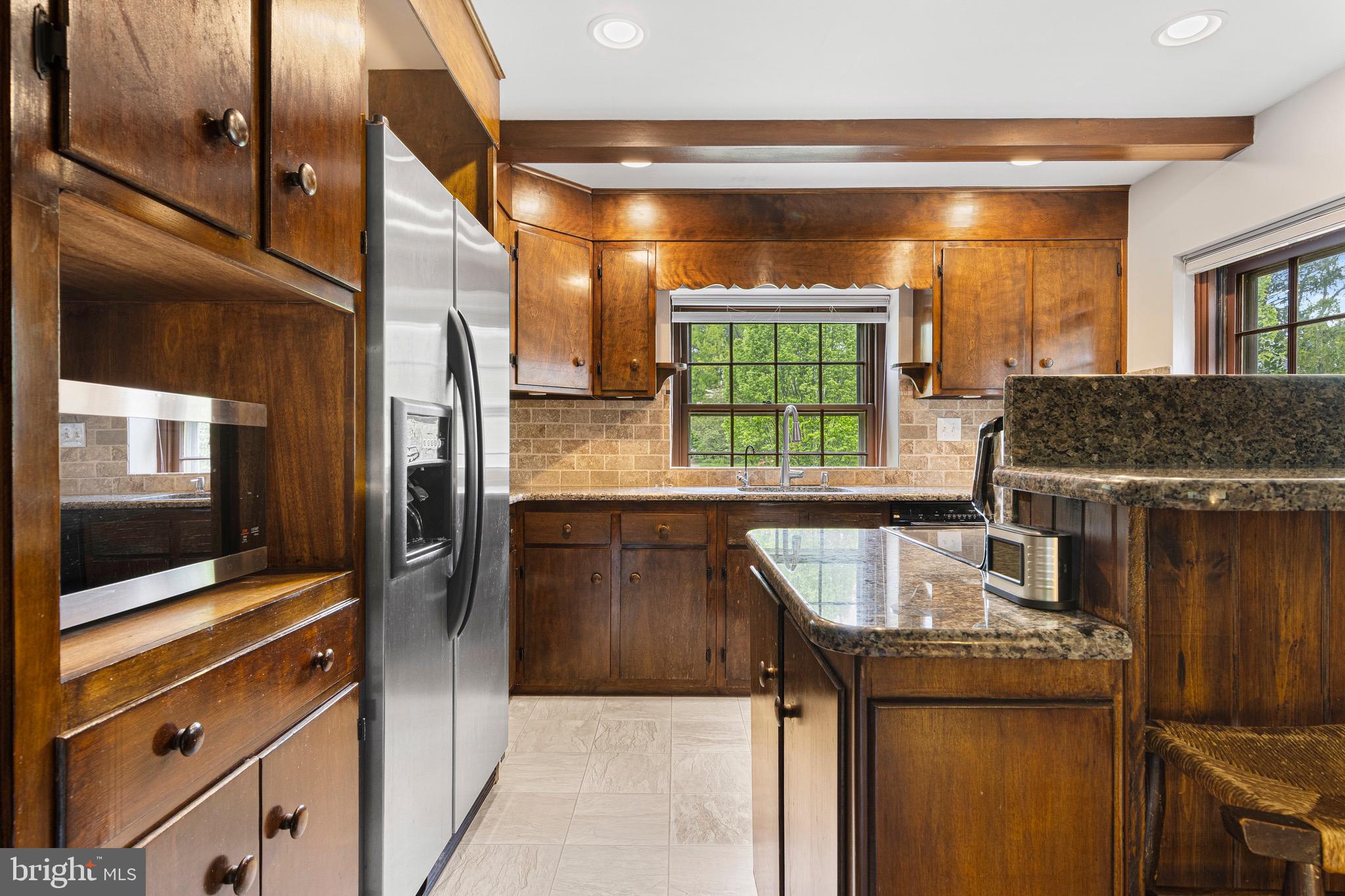 71 Forest Lane Swarthmore, PA 19081 - Photo 15 of 33 a kitchen with granite countertop a stove and a microwave
