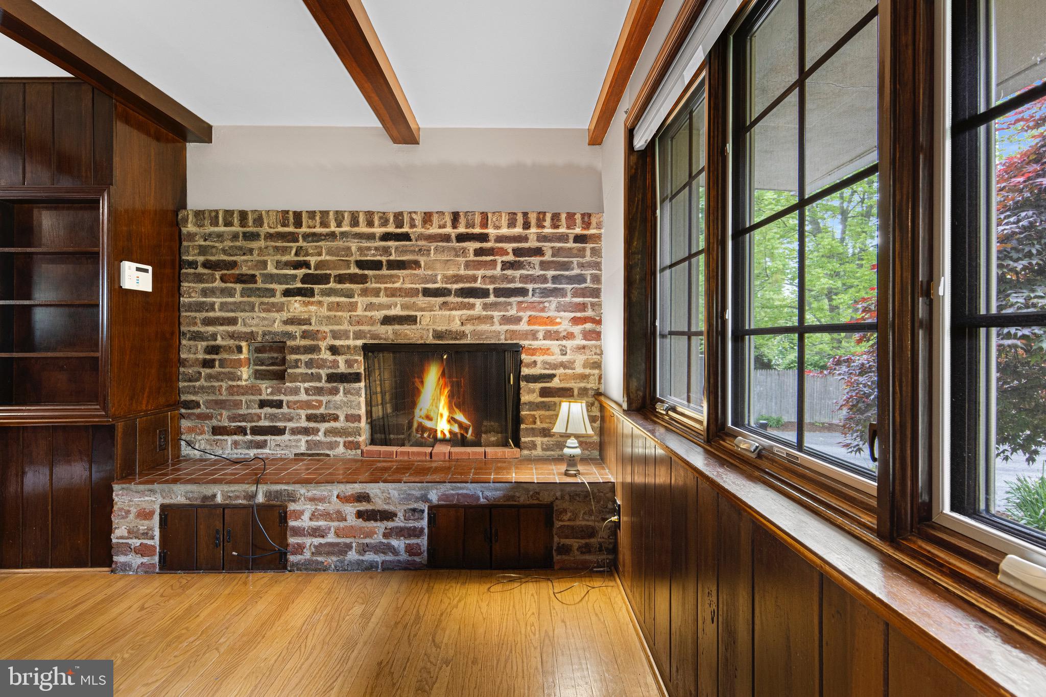 71 Forest Lane Swarthmore, PA 19081 - Photo 16 of 33 a living room with a fireplace furniture and a large window