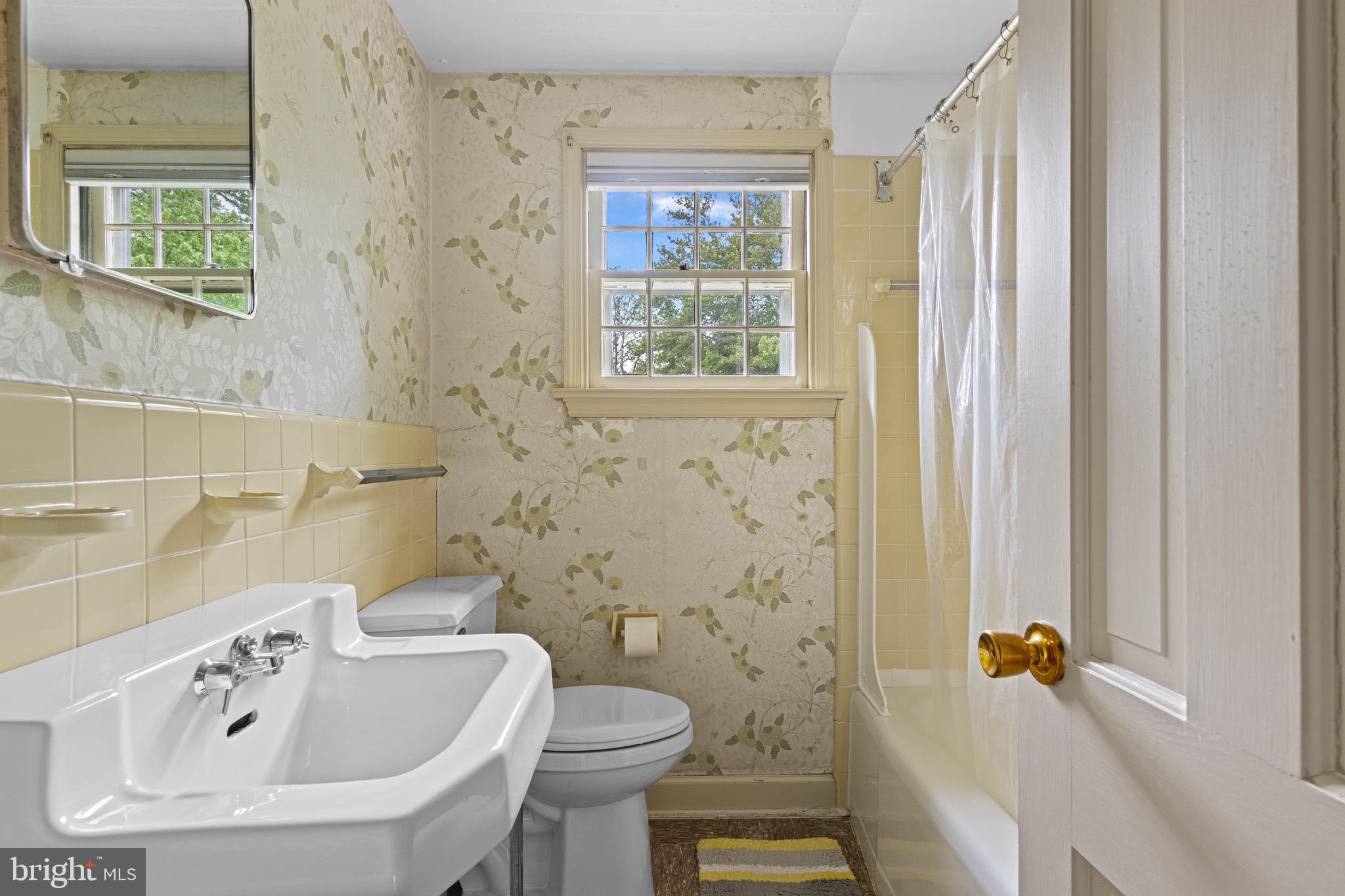 71 Forest Lane Swarthmore, PA 19081 - Photo 22 of 33 a bathroom with a sink a toilet and shower curtain