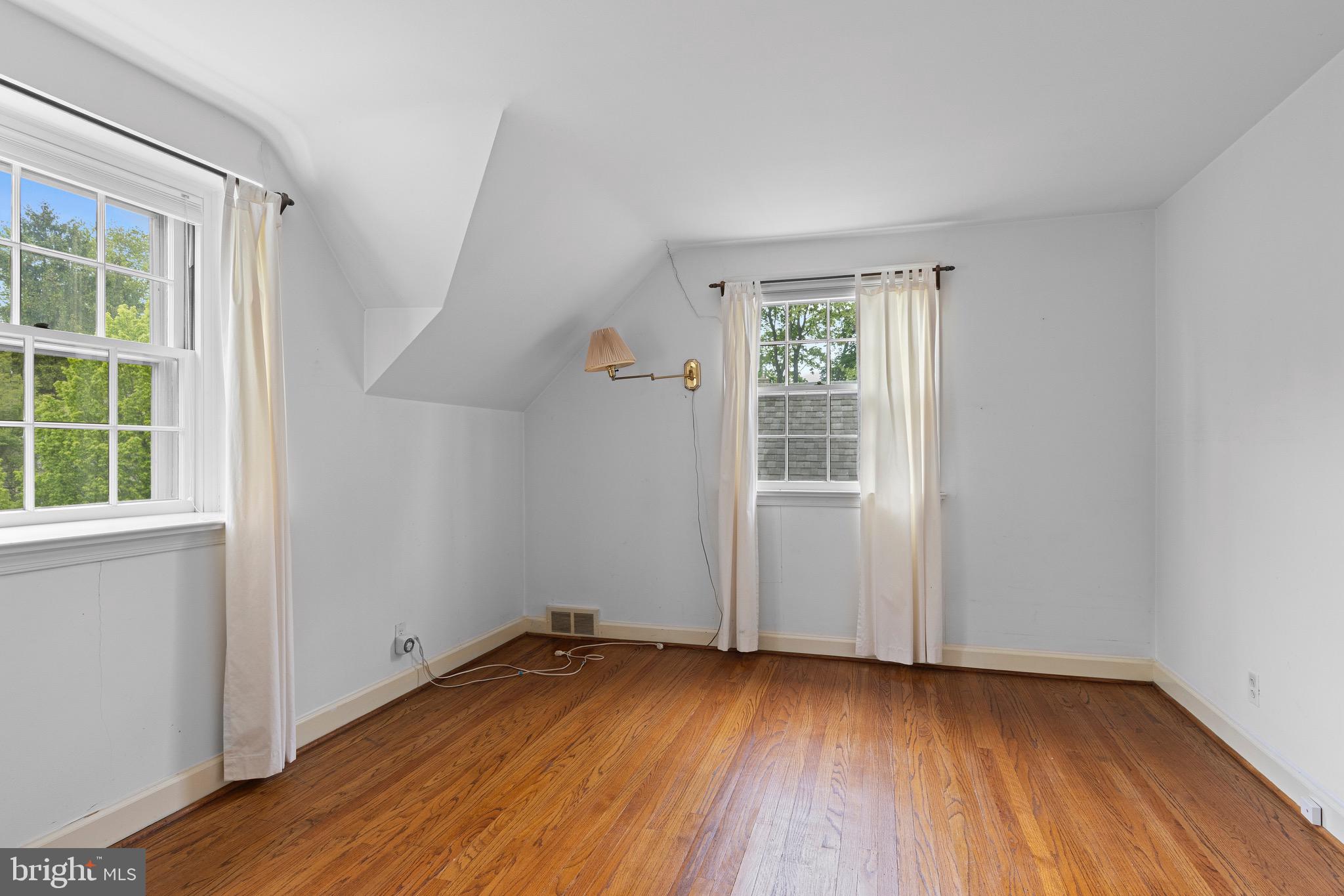 71 Forest Lane Swarthmore, PA 19081 - Photo 23 of 33 an empty room with wooden floor and windows