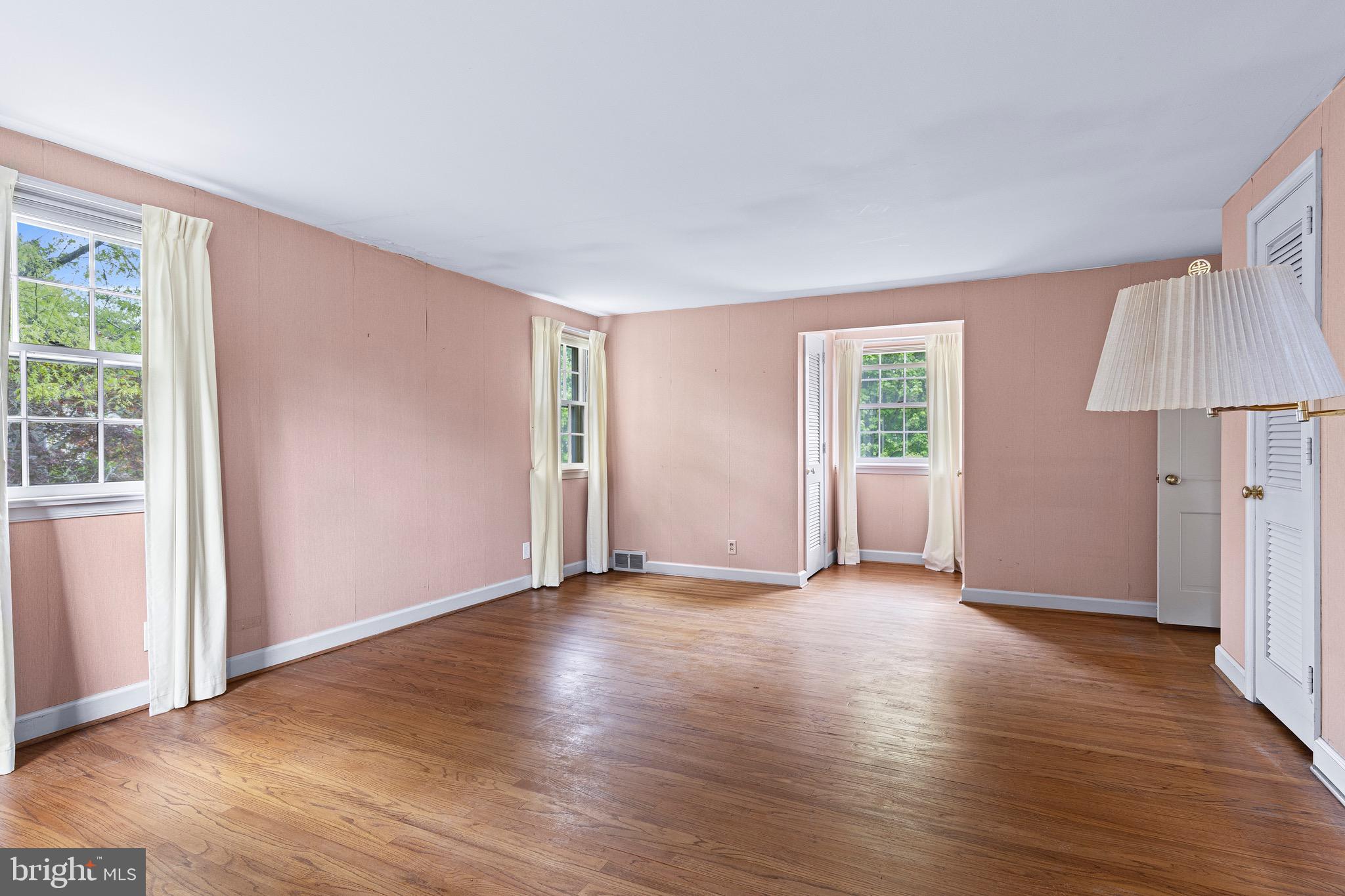 71 Forest Lane Swarthmore, PA 19081 - Photo 26 of 33 an empty room with wooden floor and windows