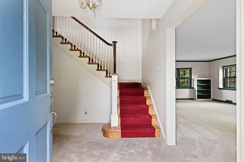 a view of a hallway with red walls and stairs