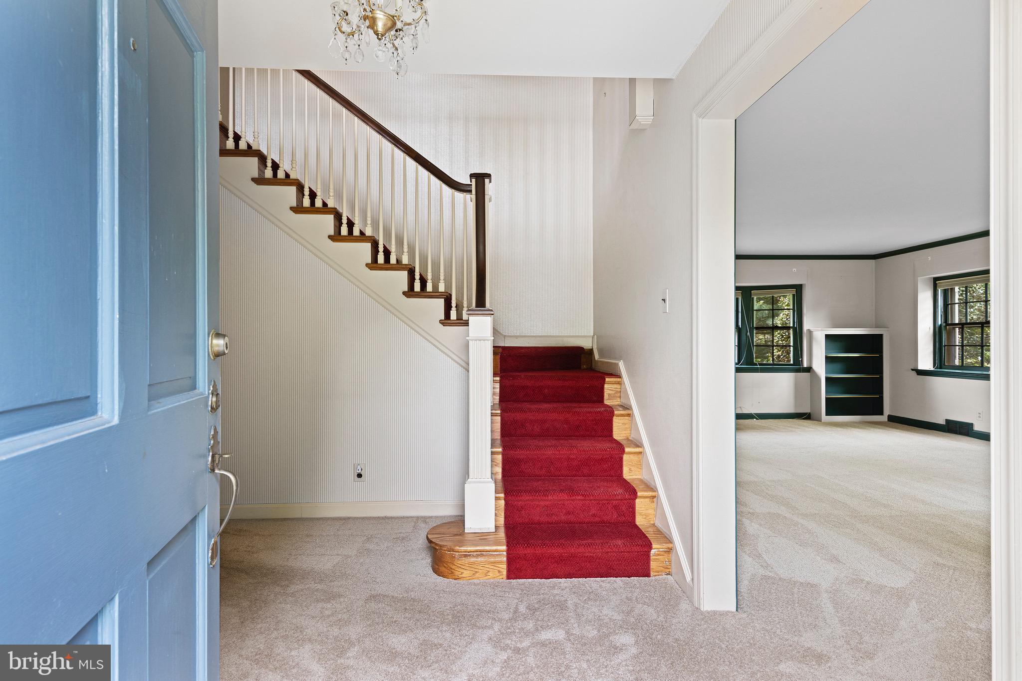 71 Forest Lane Swarthmore, PA 19081 - Photo 3 of 33 a view of a hallway with red walls and stairs