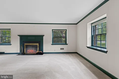 a view of an empty room with a fireplace