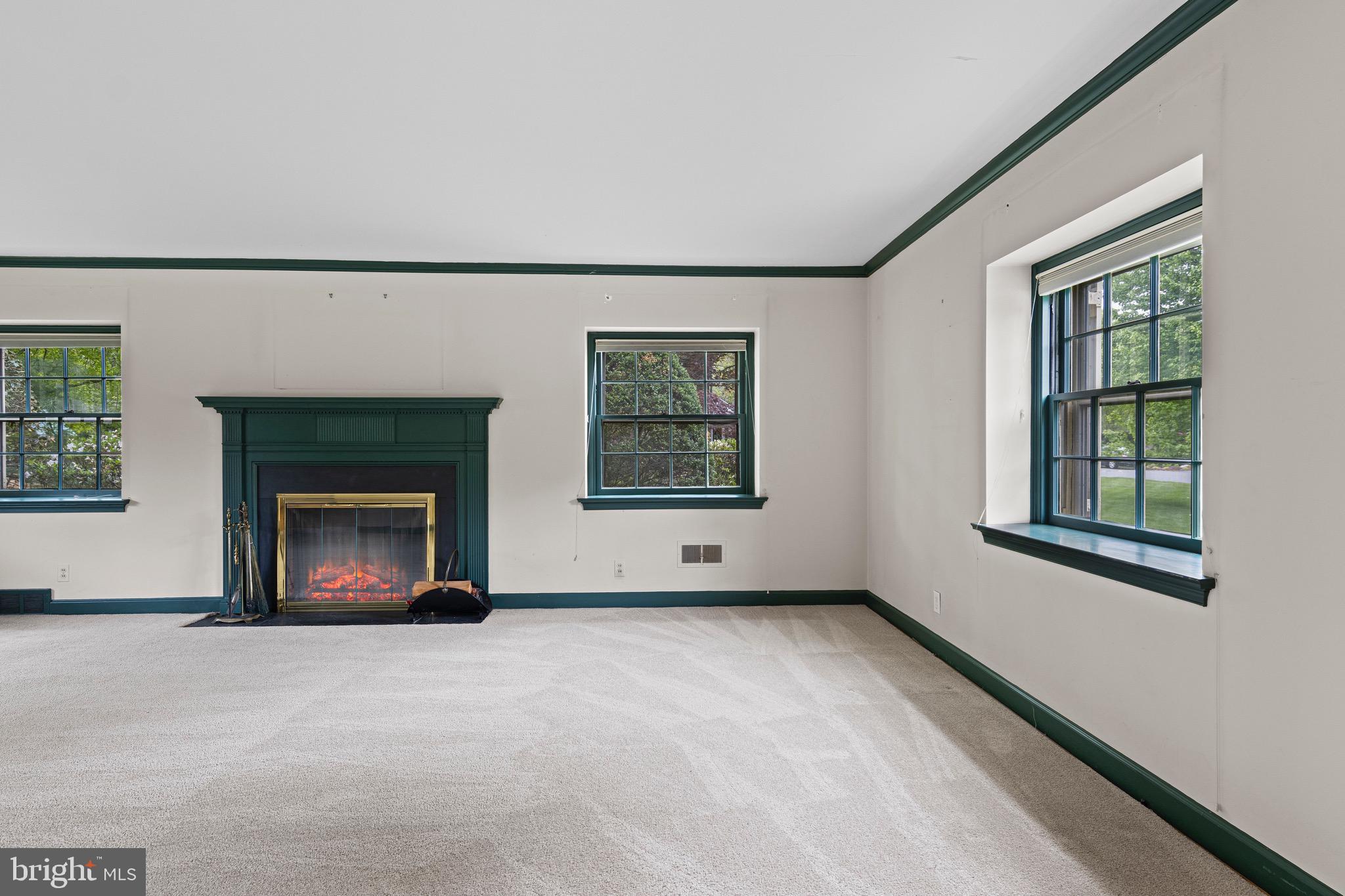 71 Forest Lane Swarthmore, PA 19081 - Photo 6 of 33 an empty room with windows and fireplace
