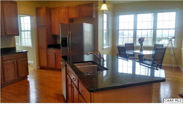 2000 Via Florence Road Charlottesville, VA 22911 - Photo 3 of 6 a kitchen open kitchen island granite countertop a refrigerator a stove and a sink with wooden floor