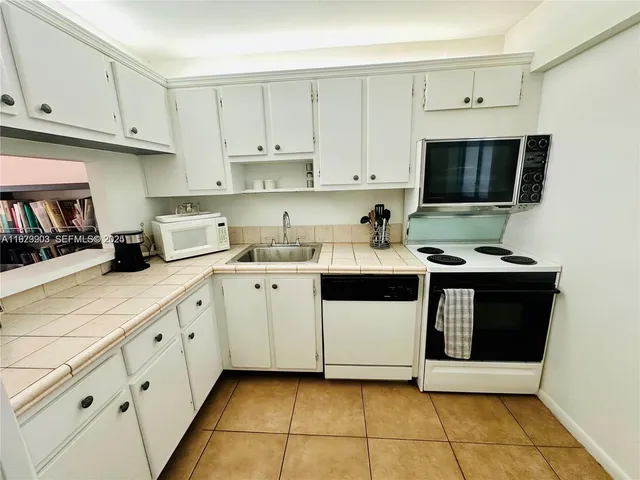 a kitchen with cabinets and appliances