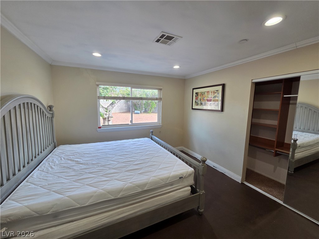 3381 Westwind Road Las Vegas, NV 89146 - Photo 43 of 52 A windowed bedroom offers ample natural light and a mirrored closet for storage convenience.
