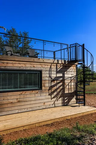 a bedroom with a bed and glass window