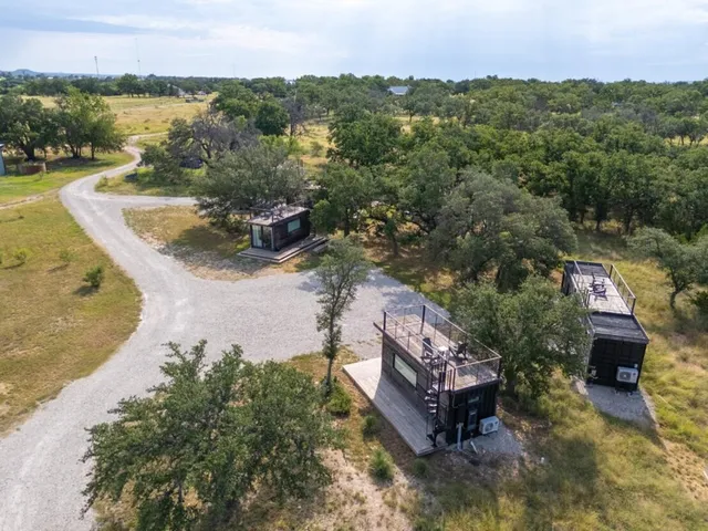 a view of a balcony with chairs and wooden floor