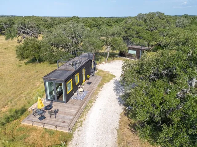 a backyard of a house with table and chairs