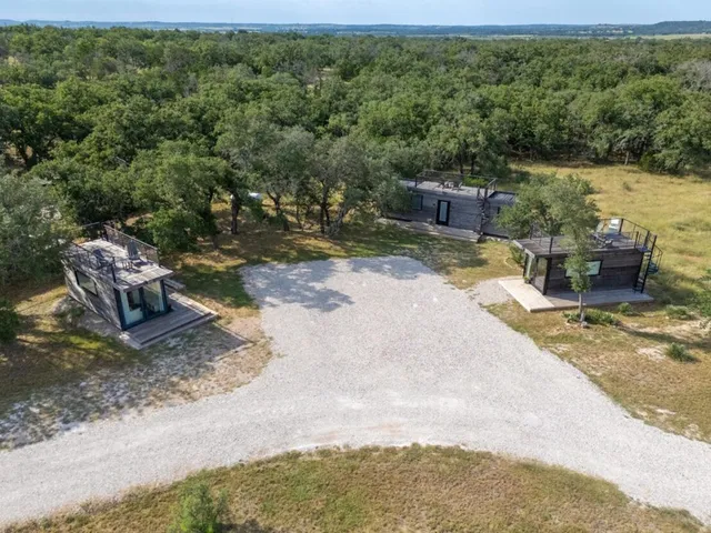 an aerial view of a house with a yard