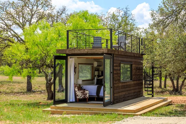 a bedroom with a bed and glass window