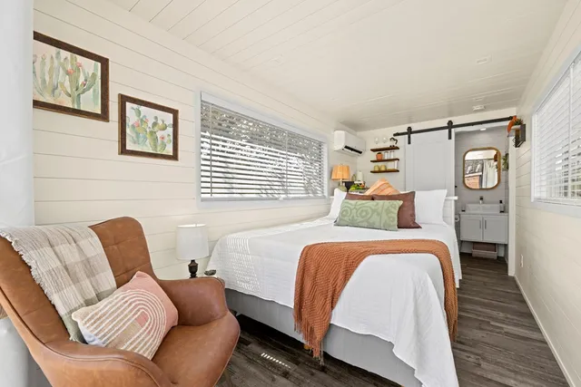 a bed room with a bed and a chair