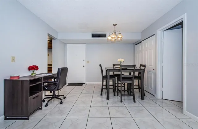 a view of a dining room with furniture and chandelier