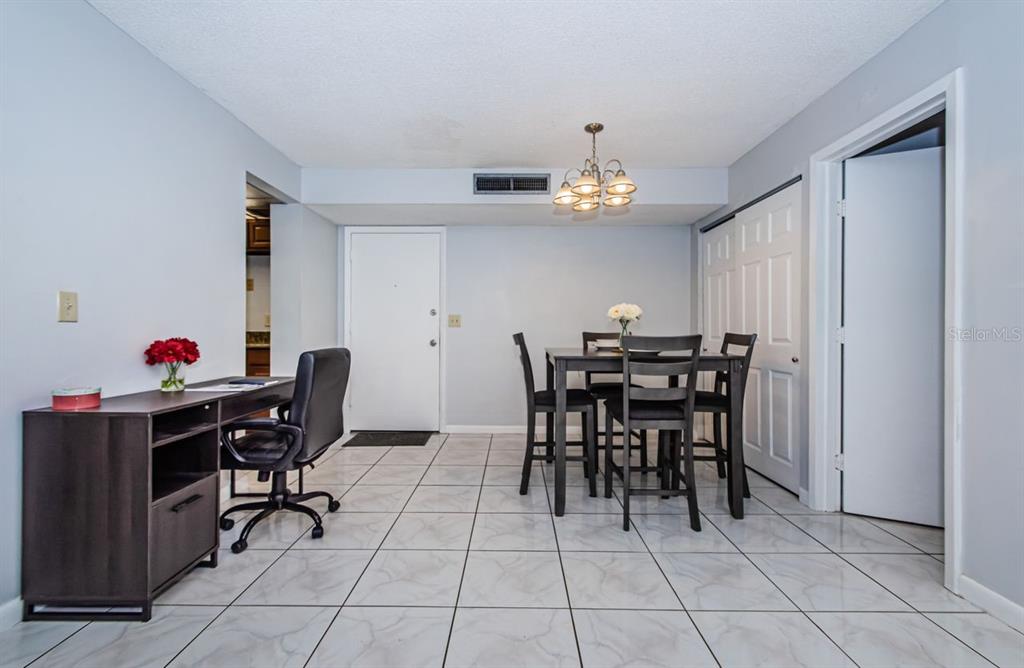 801 Russell Lane, Unit 255 Brandon, FL 33510 - Photo 16 of 38 a view of a dining room with furniture and chandelier