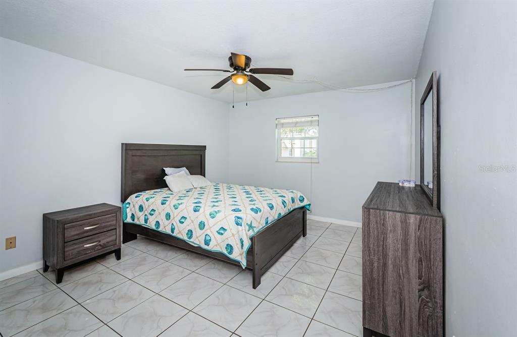 801 Russell Lane, Unit 255 Brandon, FL 33510 - Photo 18 of 38 a bedroom with a bed and a chandelier