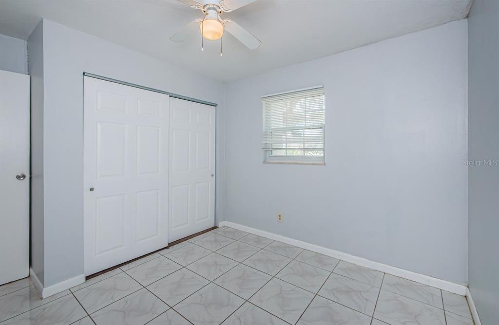 801 Russell Lane, Unit 255 Brandon, FL 33510 - Photo 25 of 38 a view of an empty room with window and chandelier fan