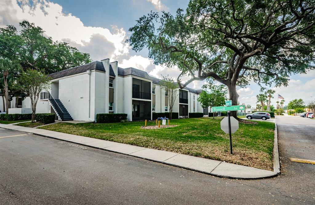 801 Russell Lane, Unit 255 Brandon, FL 33510 - Photo 3 of 38 a view of a white house with a yard and large tree