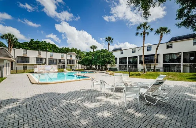 a view of a swimming pool with lounge chair
