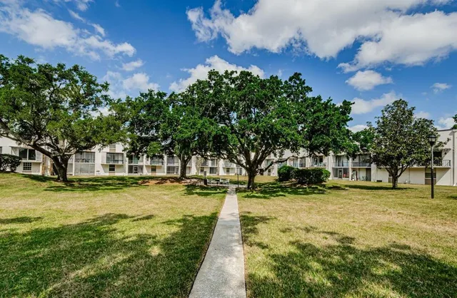 a swimming pool with trees in the background