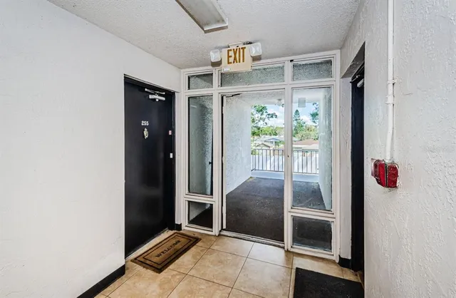a view of a room that has a bed and a chandelier