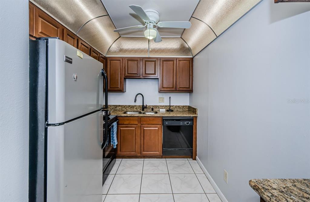 801 Russell Lane, Unit 255 Brandon, FL 33510 - Photo 5 of 38 a kitchen with stainless steel appliances granite countertop a refrigerator and a sink