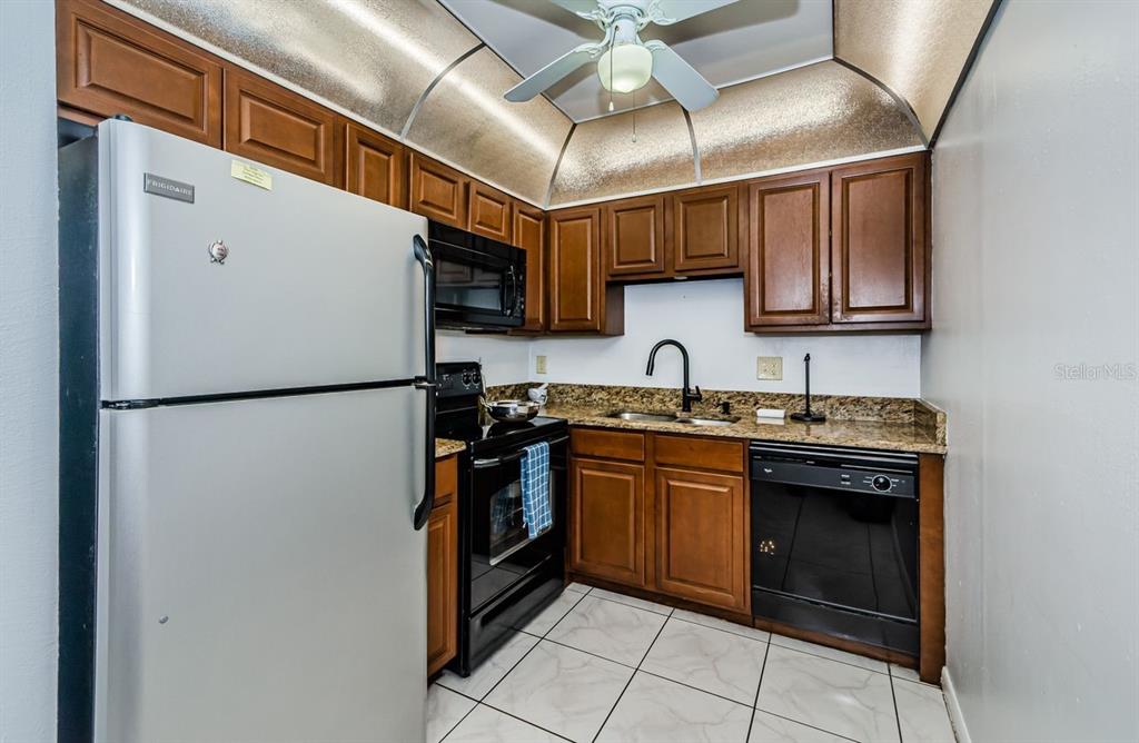 801 Russell Lane, Unit 255 Brandon, FL 33510 - Photo 6 of 38 a kitchen with stainless steel appliances granite countertop a refrigerator a sink and a stove
