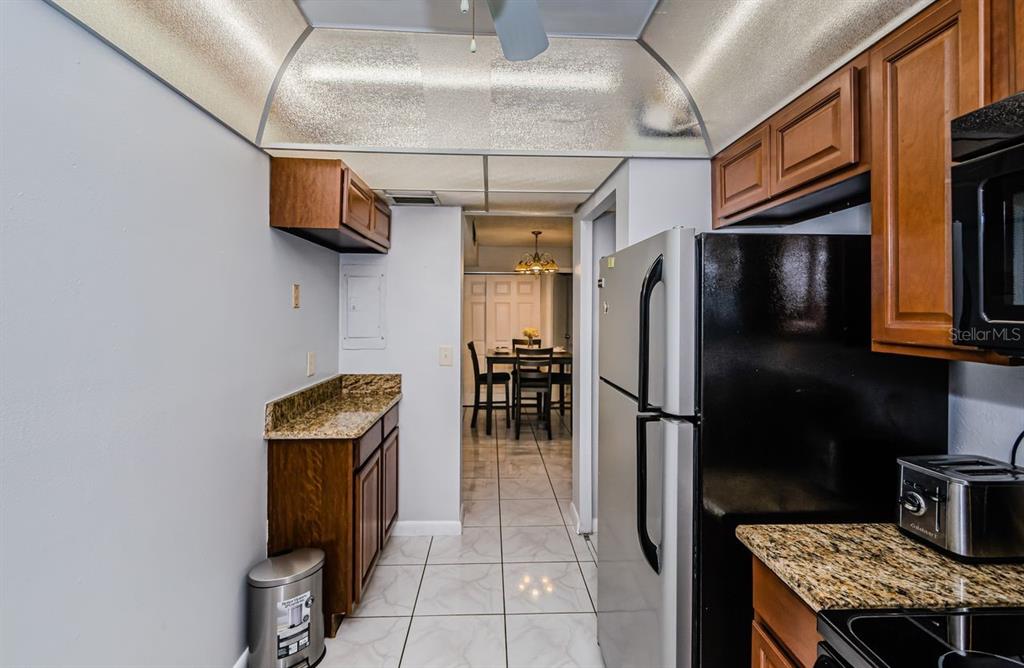 801 Russell Lane, Unit 255 Brandon, FL 33510 - Photo 8 of 38 a kitchen with stainless steel appliances granite countertop a refrigerator a stove and a sink