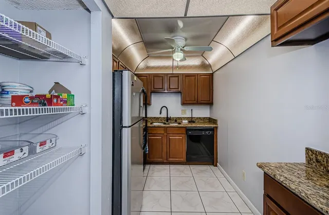 a kitchen with stainless steel appliances granite countertop a sink and cabinets