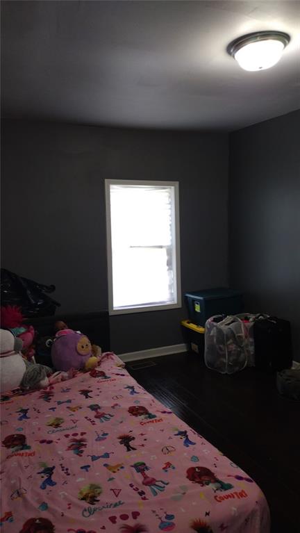 136 Hill Street Commerce, GA 30529 - Photo 20 of 27 a bed sitting in a bedroom next to a window
