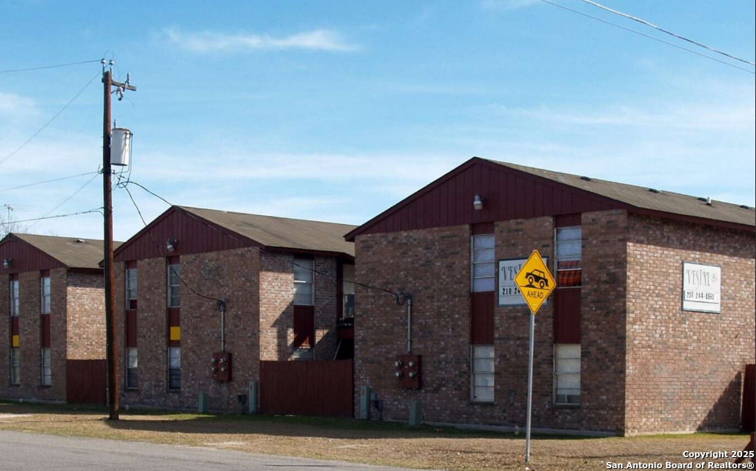 201 East Dullnig Court, Unit 9 San Antonio, TX 78223 - Photo 4 of 6 a front view of a house with yard
