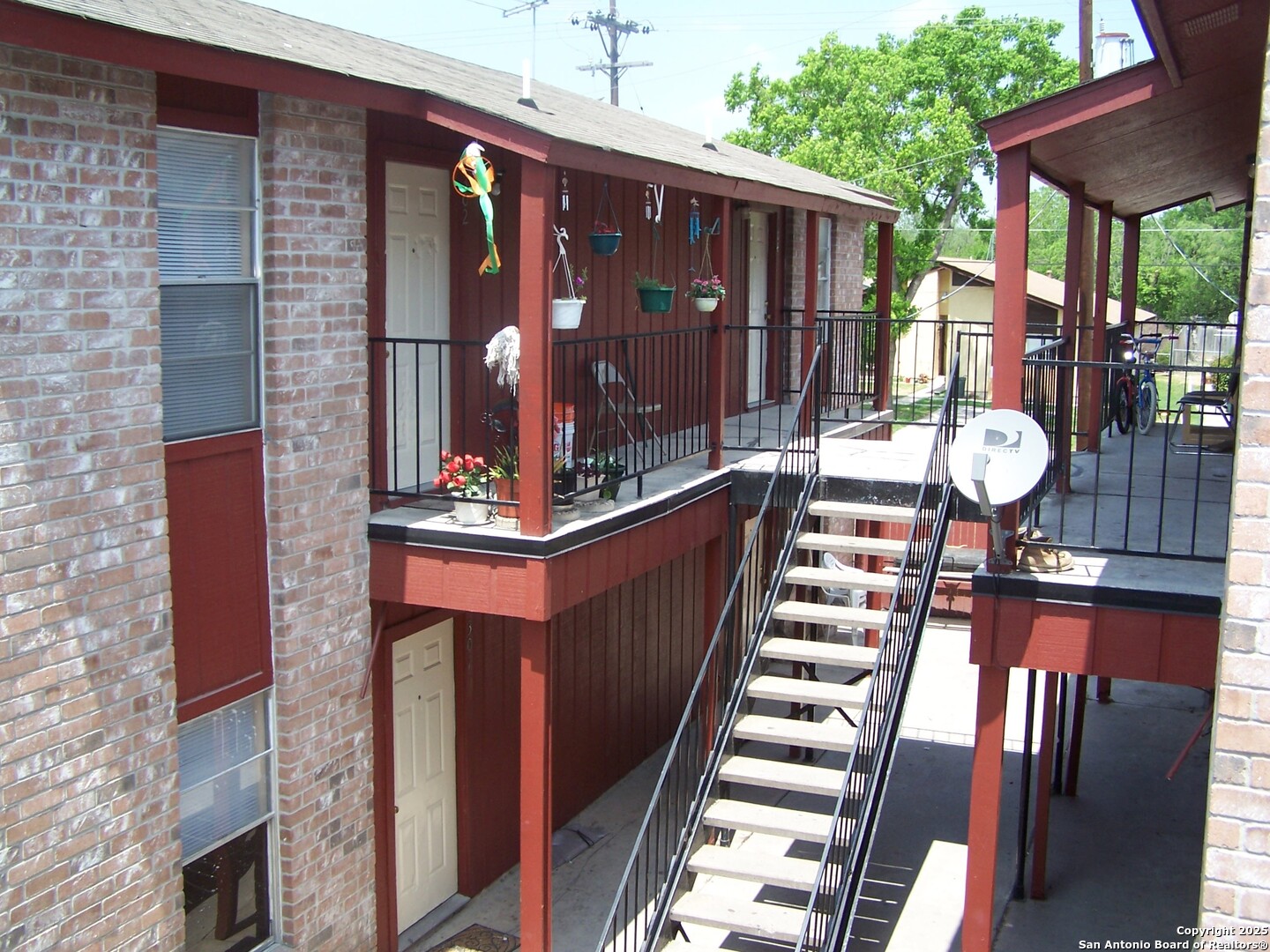 201 East Dullnig Court, Unit 9 San Antonio, TX 78223 - Photo 6 of 6 a front view of a house with outdoor seating and stairs