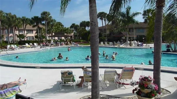 a view of a swimming pool and lounge chairs