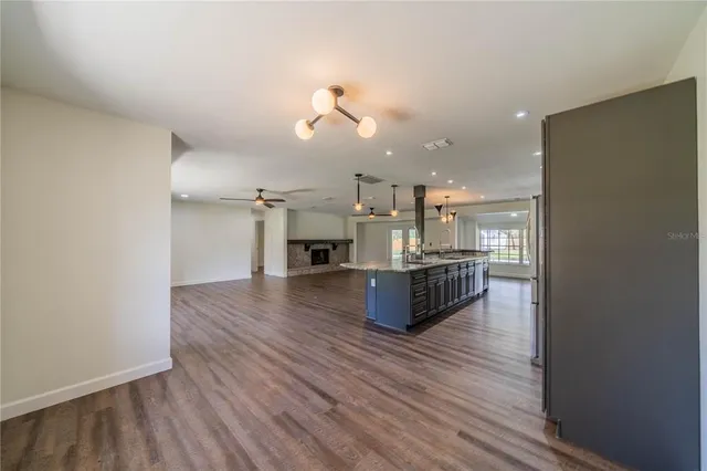 a living room with kitchen island furniture and wooden floor