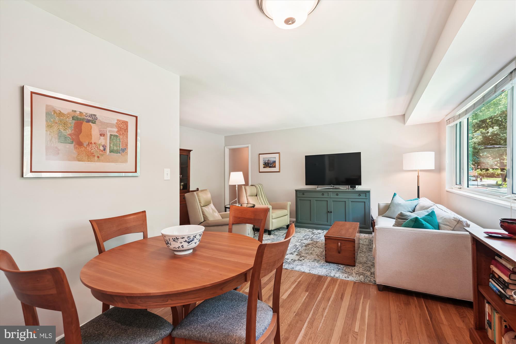10427 Montrose Avenue, Unit 104 Bethesda, MD 20814 - Photo 11 of 37 a living room with furniture a flat screen tv and a large window