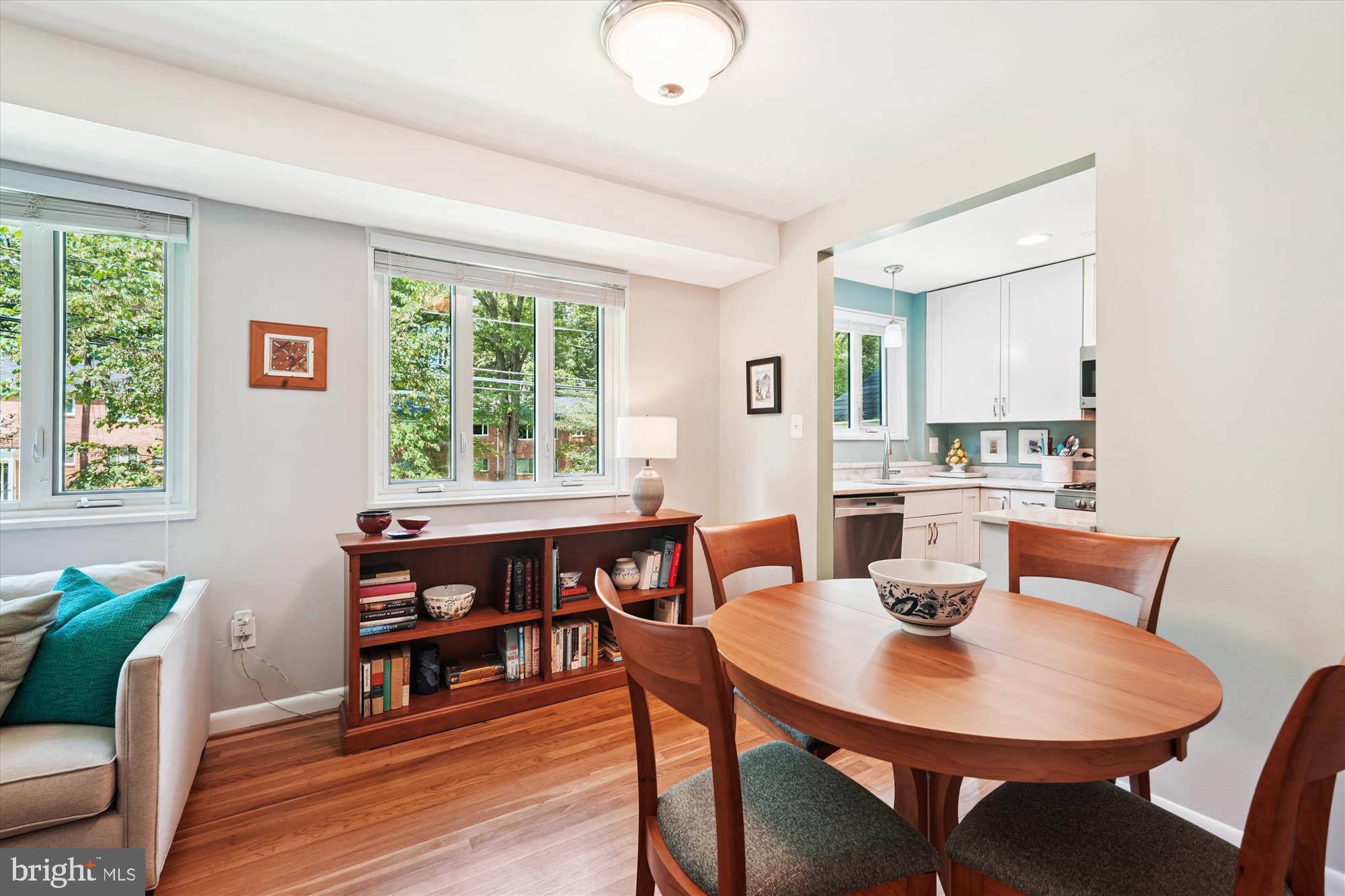 10427 Montrose Avenue, Unit 104 Bethesda, MD 20814 - Photo 12 of 37 a view of a dining room with furniture and wooden floor