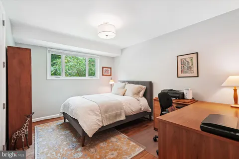 a bedroom with a bed and a lamp next to a window