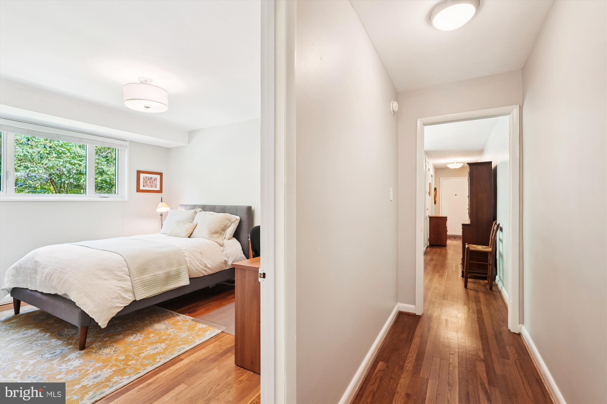 10427 Montrose Avenue, Unit 104 Bethesda, MD 20814 - Photo 21 of 37 a bedroom with a bed and a wooden floor