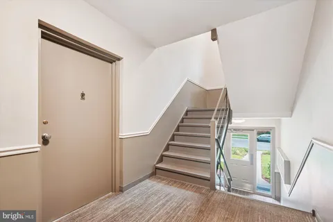 a view of entryway with stairs and wooden floor