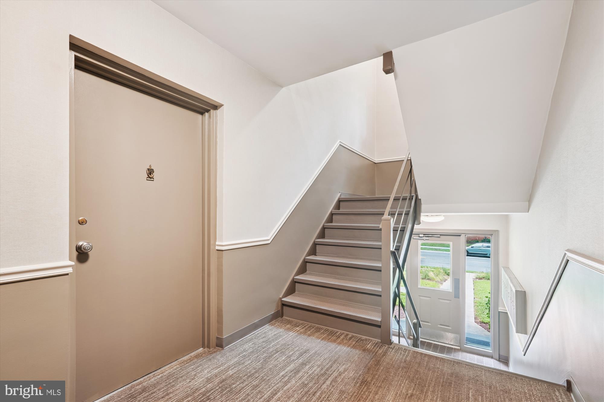 10427 Montrose Avenue, Unit 104 Bethesda, MD 20814 - Photo 23 of 37 a view of entryway with stairs and wooden floor