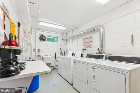 a room with sink washer and dryer