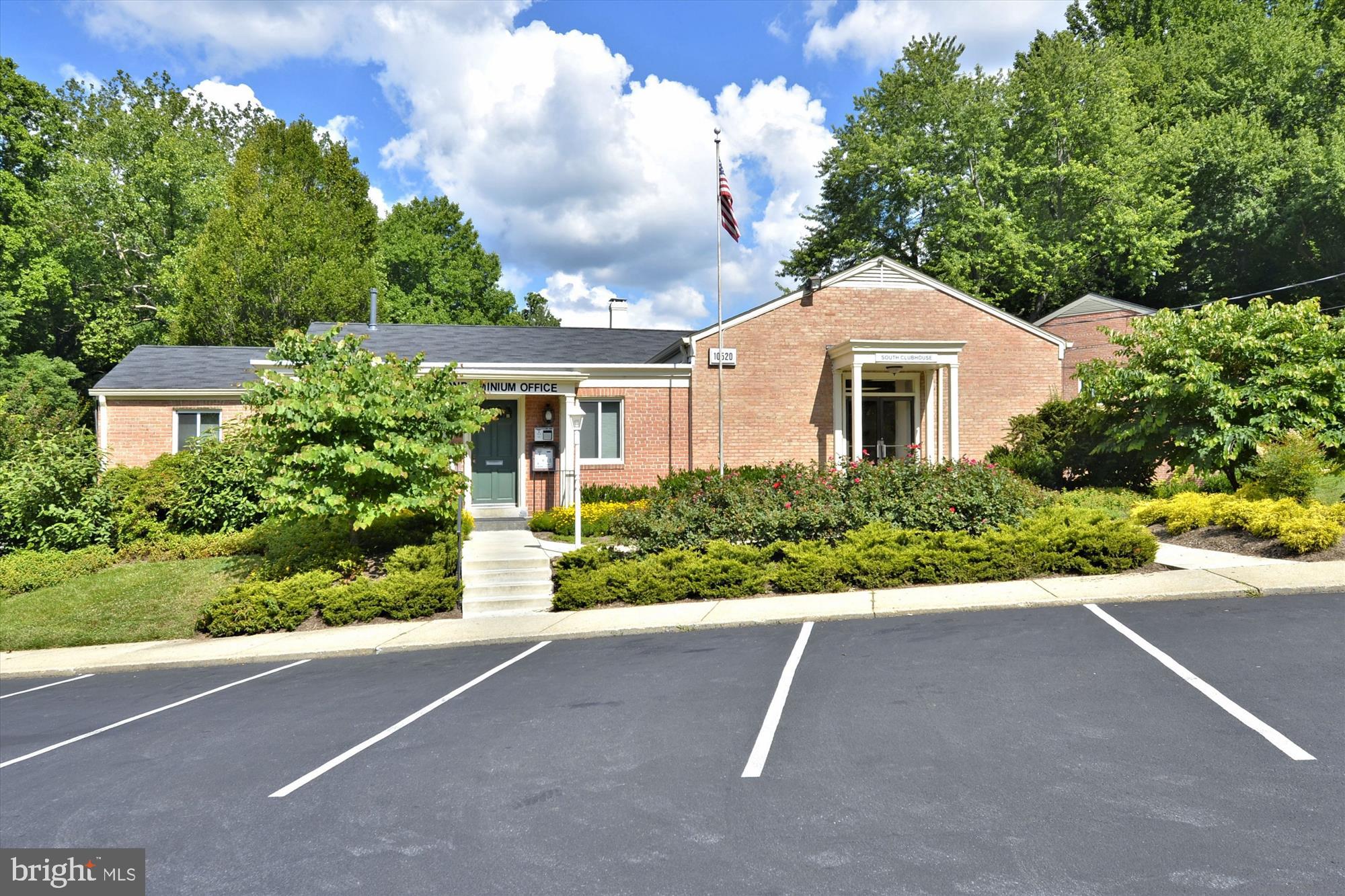 10427 Montrose Avenue, Unit 104 Bethesda, MD 20814 - Photo 30 of 37 a front view of a house with a yard and a garage