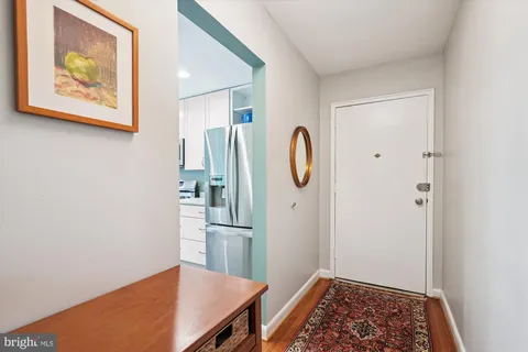 a view of kitchen with stainless steel appliances granite countertop and refrigerator