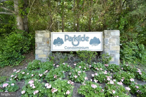 a sign that is sitting in the middle of a tree