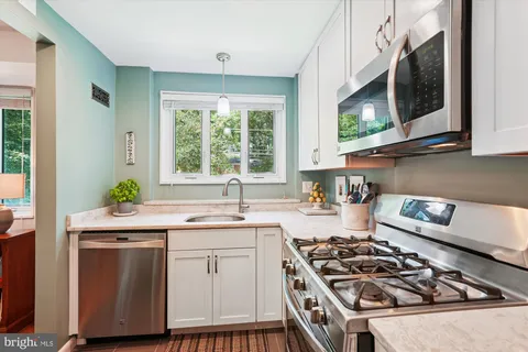 a kitchen with a stove a sink and a microwave