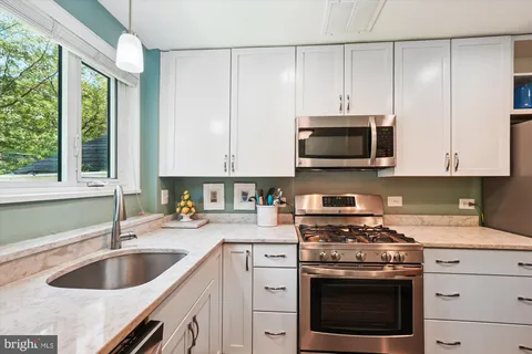a kitchen with appliances a sink and a stove