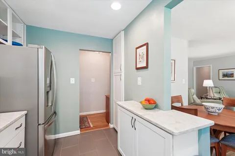 a room with a sink and a refrigerator